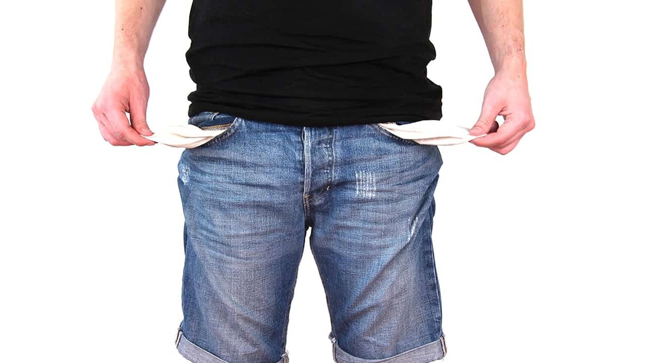Man showing empty pockets in his jeans